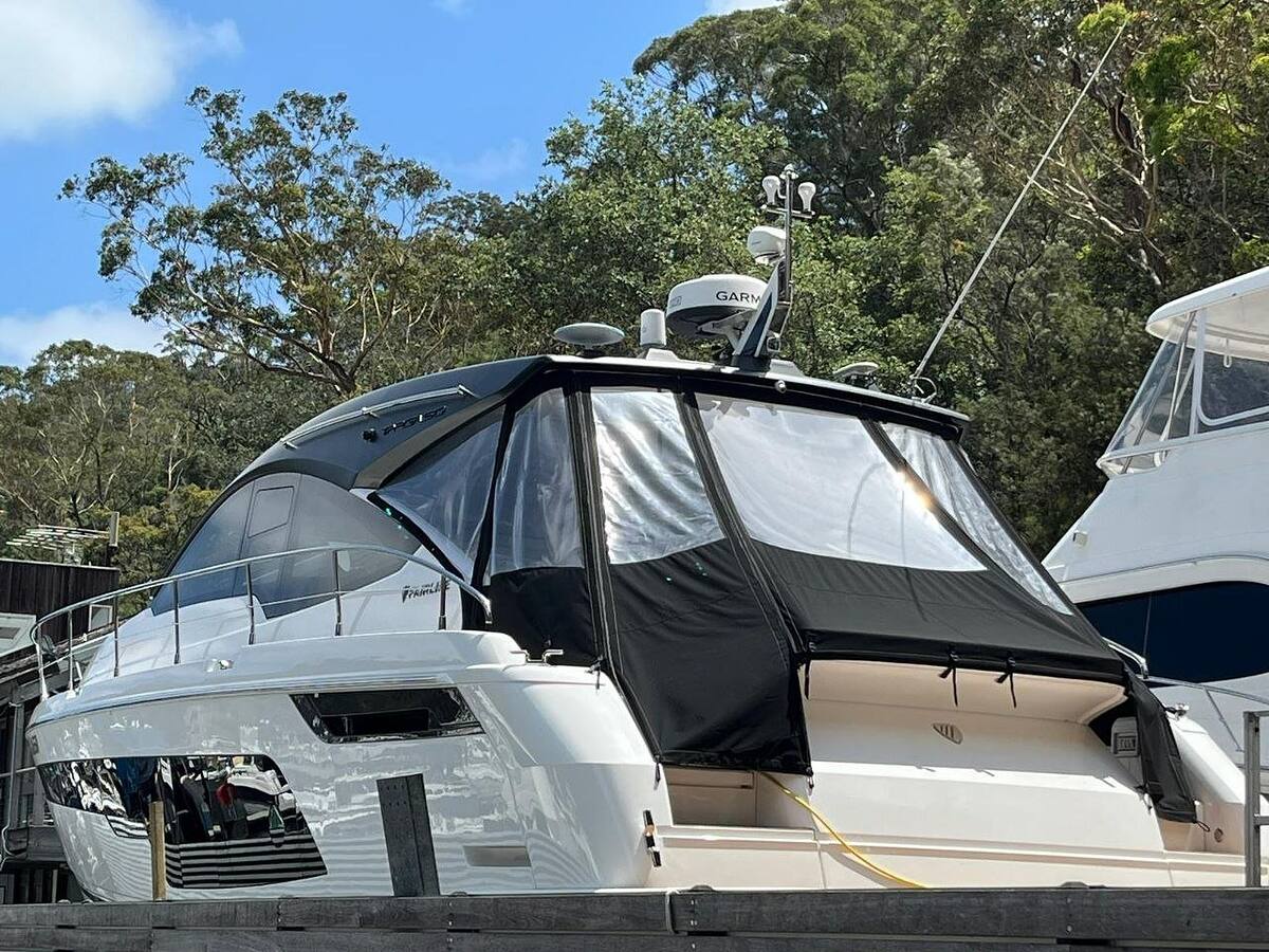 Flybridge cruiser with clean clears and covers after a detail, on the hardstand