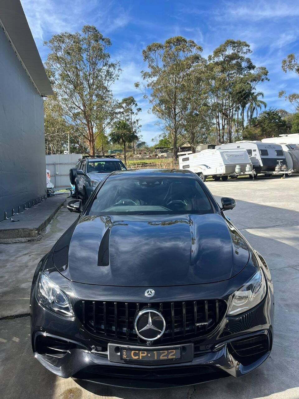 Black Mercedes-AMG with a mirror-gloss bonnet after machine polishing