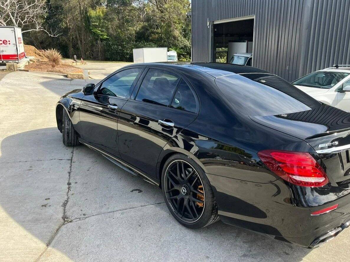 Black Mercedes sedan with swirl-free, glossy paint after a detail
